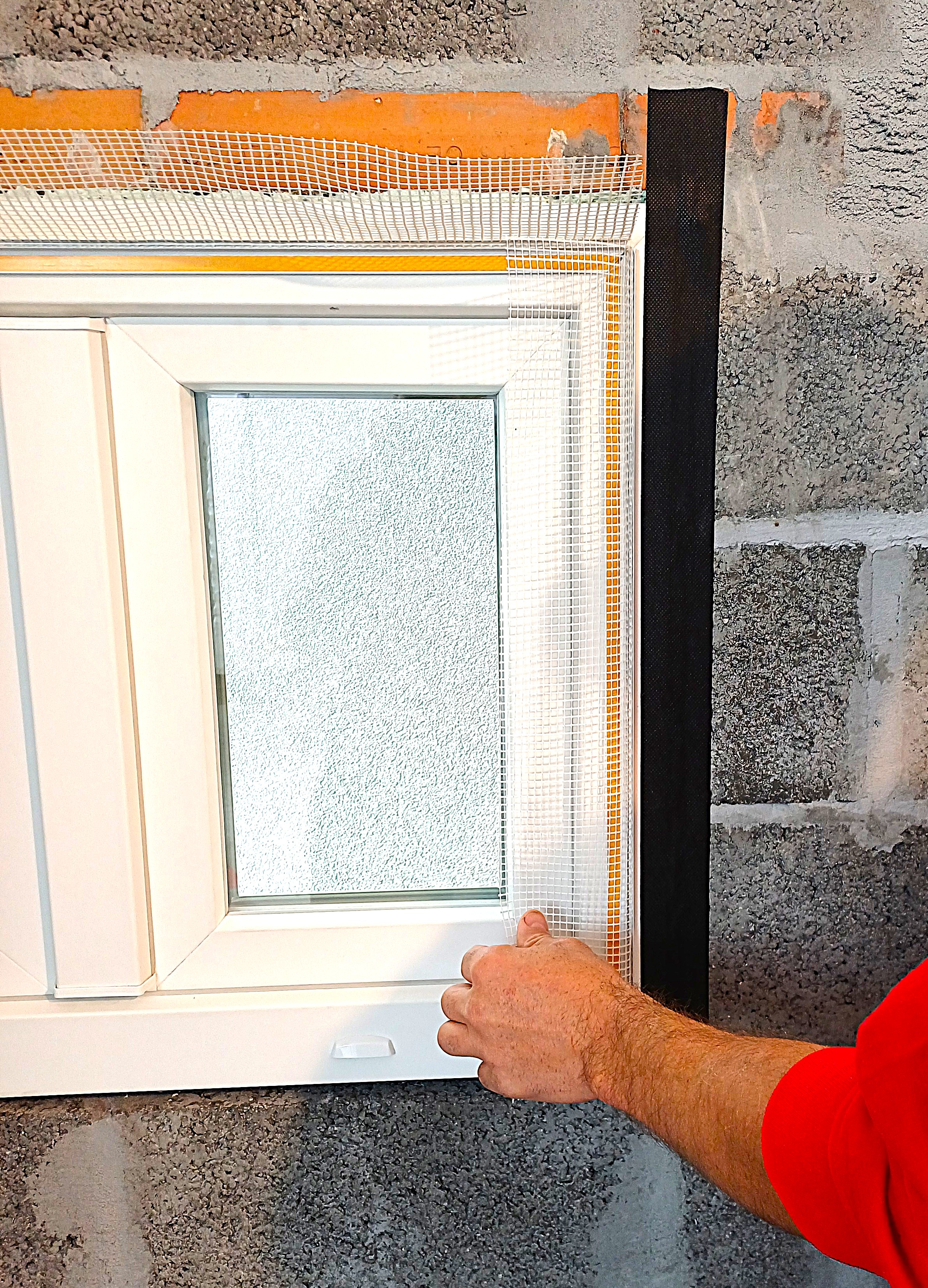Installation of vapor barrier seals on the PUR foam between the window frames and the facade walls